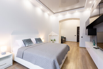 modern bedroom interior, with large bed. in light colors, beige