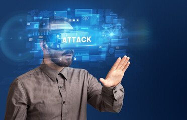 Businessman looking through Virtual Reality glasses with ATTACK inscription, innovative security concept