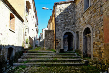 Fototapeta na wymiar An alley between the old stone houses of Castelpagano, a medieval village in the province of Benevento.