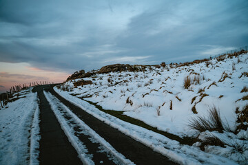 Snowy road on the hills of Jaizkibel with a beautiful gradient sunset sky in the background