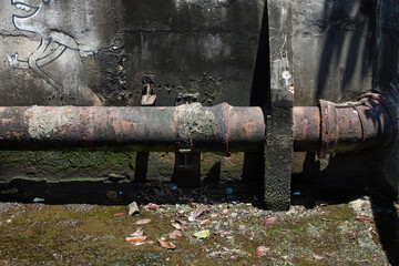Rusted pipe in a river channel