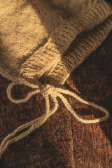 a knitted and embroidered winter hat for newborns in a traditional pattern. soft brown colors