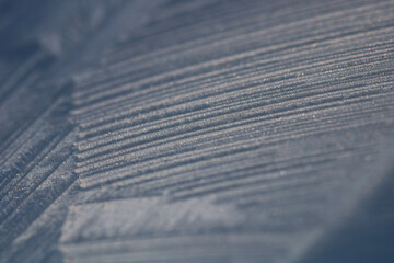 Large linear ice crystals growing across a surface. Macro with shallow depth of field. Depth of winter ice formations.