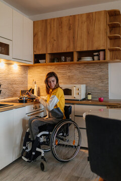 Smiling woman in wheelchair cooking