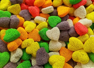 Colorful candies. Heart-shaped candies. Yellow, red, green candies.