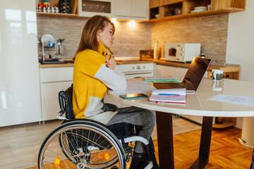 Disabled woman working at home with the help of technology