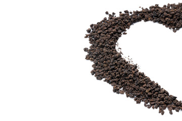 black tea granules isolated on white background. design element. heart symbol made by dry tea heap cut out