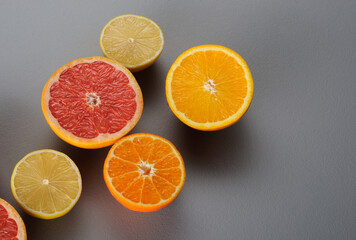 Fototapeta na wymiar Top view of oranges, lemons, tangerines, grapefruit on a gray background, top view.Citrus juice ingredients, food background