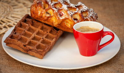 Pastries and espresso coffee on a burlap background