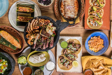 Variety of tasty Mexican food on a restaurant table