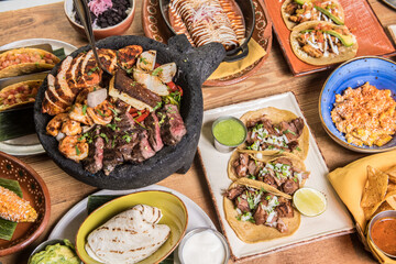 Variety of tasty Mexican food on a restaurant table