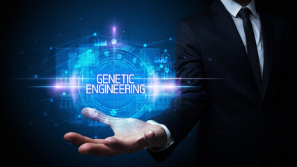 Man hand holding GENETIC ENGINEERING inscription, technology concept