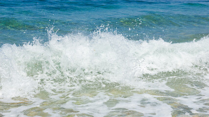 Sea wave and pebble. Summer vacation concept. Sea wave with foam incident on the coastal shingle. Travel concept