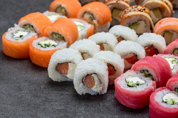 Sushi set with tuna, shrimp, salmon, and rice on the dark background
