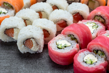 Sushi set with tuna, shrimp, salmon, and rice on the dark background
