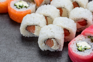 Sushi set with tuna, shrimp, salmon, and rice on the dark background