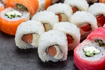 Sushi set with tuna, shrimp, salmon, and rice on the dark background