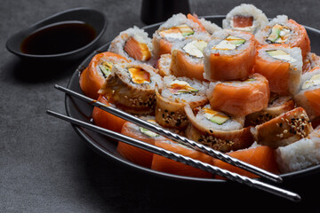 Sushi set in plate on the dark background closeup