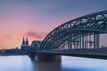 Hohenzollern Bridge over the Rhine River and Cologne Cathedral on sunset 