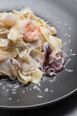 Pasta with sqid, salmon and parmezan