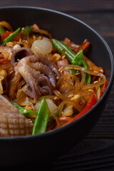 Ramen noodles with shrimp and octopus in bowl closeup