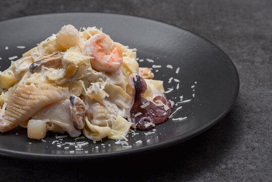 Pasta with sqid, salmon and parmezan