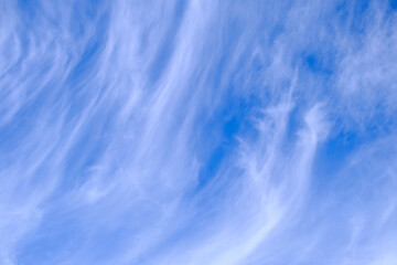 Background of wispy white clouds in a blue sky