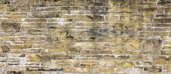 Weathered wall from wild stones, retro surface