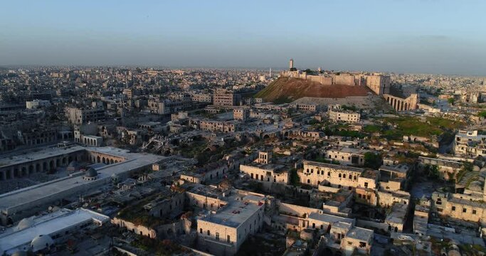 Aerial view of the citadel of Aleppo under the sunset. We can see the syrian city all over the horizon 4K