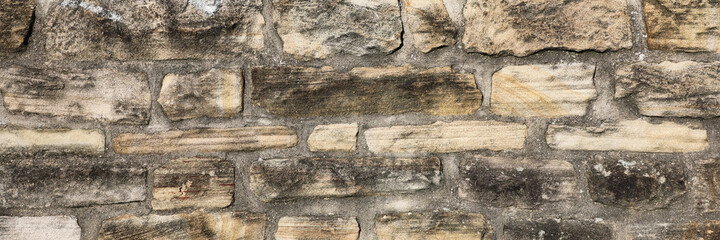 Weathered wall from wild stones, retro surface