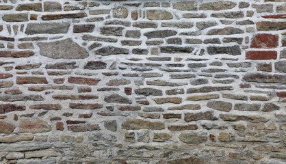 Weathered wall from wild stones, retro surface