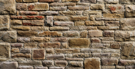 Weathered wall from wild stones, retro surface