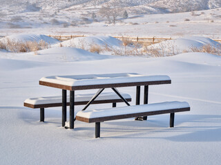 picnic table covered by fresh snow at foothills of Rocky Morning - Lory State Park in northern Colorado