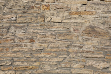 Weathered wall from wild stones, retro surface