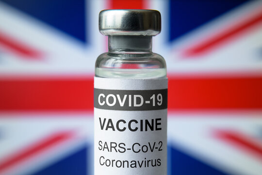 COVID-19 Coronavirus Vaccine Bottle On UK Flag Background