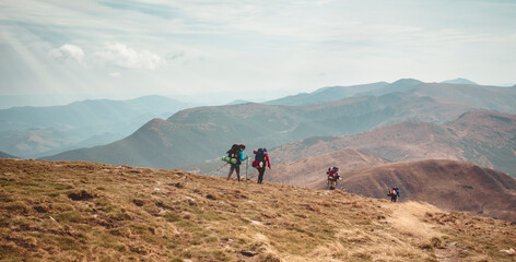 A group of tourists are walking along the route through the mountains of Ukraine. Success concept....