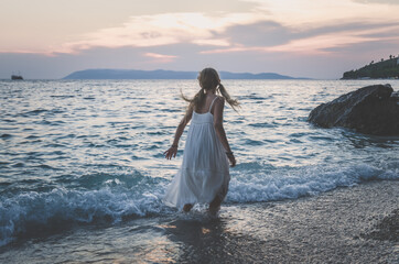 child and sea, loneliness and freedom, wild dance at the sunset