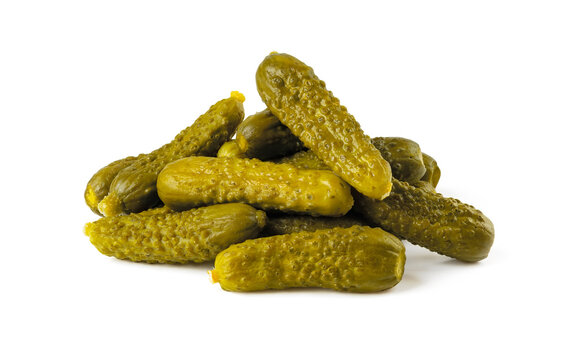 Pile of pickled gherkins isolated on a white background. Whole green cornichons marinated with dill, garlic and mustard seeds. Crunchy baby pickles. Tasty canned vegetables.