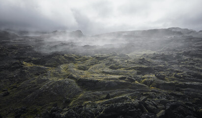 Steam clouds in lava field. Volcanic rocks