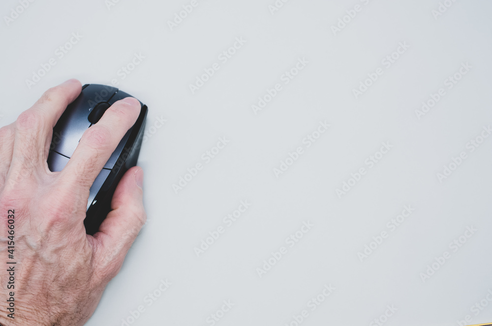 Aufkleber closeup shot of an old person's and using a computer mouse on a white surface with a copy space