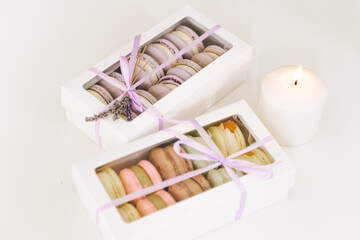 Macaroons colorful cookies in box on white  table.Above view on a cookie in gift box,selective focus