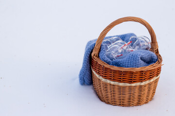 Fototapeta na wymiar Jars for hijama in a basket in the snow. Wicker basket. Bloodletting according to the Sunnah. Vacuum therapy. medical and health concept. Winter and snow.