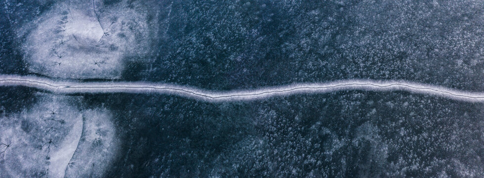 Abstract pattern of cracked ice in half, simetric texture view from top