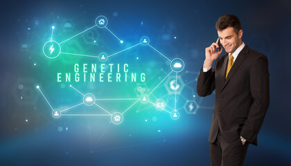 Businessman in front of cloud service icons with GENETIC ENGINEERING inscription, modern technology concept