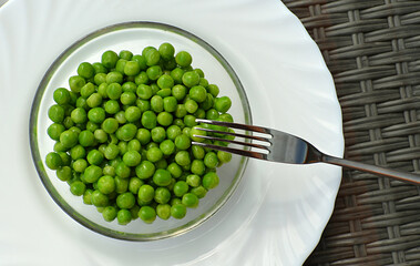 Fresh green peas are on a plate