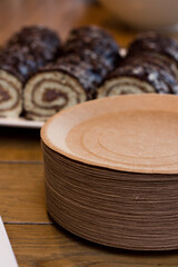 Paper plates with chocolate rolls. Disposable paper plates