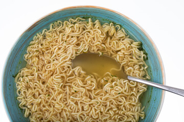 Bowl of instant noodle soup with silver spoon