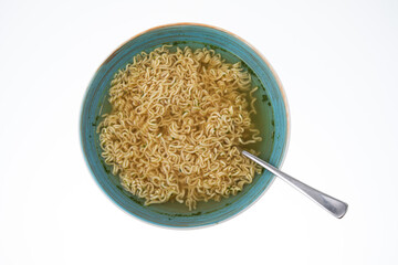Bowl of instant noodle soup with silver spoon