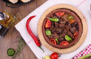 roasting meat in a casserole cooked on a wood fire in the oven