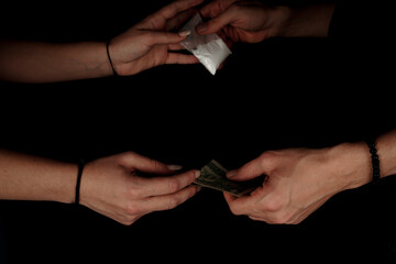 Hand of addict woman with buying dose of cocaine from drug dealer. Narcotics concept. Horizontal...